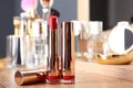 Lipsticks in gold tubes on dressing table Royalty Free Stock Photo