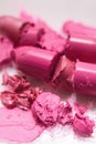 Lipsticks pink broken on white background