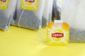 Lipton Yellow Label black tea bags on pastel yellow surface close up. Lipton is a world famous brand of tea