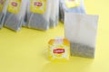 Lipton Yellow Label black tea bags on pastel yellow surface close up. Lipton is a world famous brand of tea