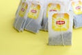 Lipton Yellow Label black tea bags on pastel yellow surface close up. Lipton is a world famous brand of tea