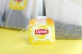 Lipton Yellow Label black tea bags on pastel yellow surface close up. Lipton is a world famous brand of tea