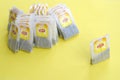 Lipton Yellow Label black tea bags on pastel yellow surface close up. Lipton is a world famous brand of tea