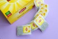 Lipton Yellow Label black tea pack and teabags on pastel lilac surface close up. Lipton is a world famous brand of tea