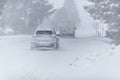 Liptov, Slovakia - JANUARY 30, 2022. Car covered in snow driving in snowstorm on a cold winter day