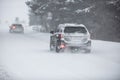 Liptov, Slovakia - JANUARY 30, 2022. Car covered in snow driving in snowstorm on a cold winter day