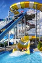 Family sliding down on inflatable in water slide in aquapark Tatralandia in Slovakia Royalty Free Stock Photo