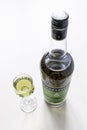 Liqueur glass and bottle of Chartreuse liqueur