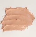 Liquid beige Foundation smeared on a white background