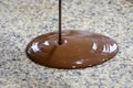 Liquid chocolate is poured on a granite table. Close-up Royalty Free Stock Photo