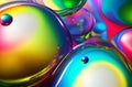 Liquid Colors in a Transparent Orb and Bubbling Glass Spinning in Rolled Colors Background.