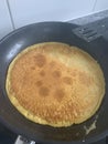 Chickpea pancake in the frying pan