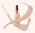 Liquid foundation in bottle and splashes of makeup product on light beige background Royalty Free Stock Photo