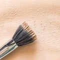 Liquid foundation texture background with duofibre brush. Neutral beige corrector Royalty Free Stock Photo