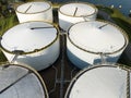 Liquid or gas storage silos. Heavy industry industrial tank container top down aerial drone view. Chemical liquid metal