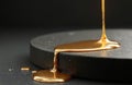 Liquid gold drips onto solid black surface. Contrasting textures of fluid metal and dark matte stone create elegant abstract Royalty Free Stock Photo