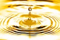 Liquid gold drop and ripple Royalty Free Stock Photo