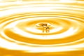 Liquid gold drop and ripple Royalty Free Stock Photo