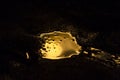 Liquid gold is spilled in a dark room Royalty Free Stock Photo