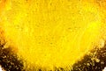 Liquid gold-yellow gasoline bubbles background on beer or champagne glass. Close up, macro shot Royalty Free Stock Photo
