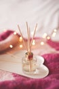 Liquid home fragrance with sticks in glass bottle closeup. Home refreshment Royalty Free Stock Photo