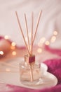 Liquid home fragrance with aroma sticks in bottle closeup. Home refreshment Royalty Free Stock Photo