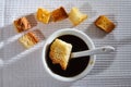 Liquid honey in a white plate and Square toasted pieces of homemade delicious rusk, hardtack, Dryasdust, zwieback on a white