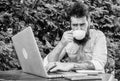 A liquid hug for his brain. Hipster enjoying coffee and free wifi in outdoor cafe. Bearded man drinking coffee and Royalty Free Stock Photo
