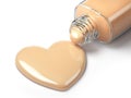 Liquid makeup foundation cream in form of the heart symbol and g