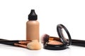 Liquid makeup foundation cream and  shadow, blush, powder, sculptor in a pack with make up brushes on a white background. Isolated Royalty Free Stock Photo