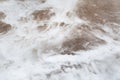 Liquid nitrogen spilled on the ground, close-up view of steam