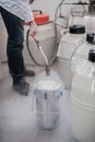 Liquid nitrogen technician fills container Royalty Free Stock Photo
