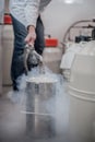Liquid nitrogen technician fills container Royalty Free Stock Photo