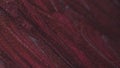 Liquid paint background shimmering burgundy glitter