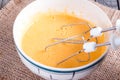 Liquid pumpkin dough on a wooden background