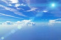 Cloudy blue sky on a sunny day. The Sun and the Sun`s rays against the blue sky and clouds. Royalty Free Stock Photo