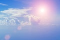 Cloudy blue sky on a sunny day. The Sun and the Sun`s rays against the blue sky and clouds. Royalty Free Stock Photo