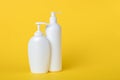 Liquid soap in a flacon. Set of plastic bottles with dispenser on a yellow background. Copy space, empty place for text. Pump