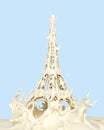 Liquid splash of white milk cream or yogurt in eiffel tower paris form, isolated on background.