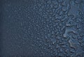 Liquid water droplets, abstract shapes, small and big on a black Royalty Free Stock Photo