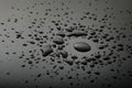 Liquid or water drops splash on the black floor Royalty Free Stock Photo
