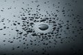 Liquid or water drops splash on the black floor Royalty Free Stock Photo