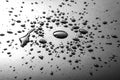 Liquid or water drops splash on the black or silver floor Royalty Free Stock Photo