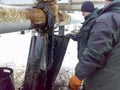 Liquidation of the oil spill. Locksmiths are engaged in eliminating oil leakage and repairing equipment. Workers liquidate the oil