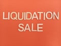 Liquidation sale sign on an orange background Royalty Free Stock Photo
