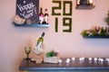 Liquor bar and many alcohol drinks behind the bar with vintage lamps. Happy new year bokeh inscription