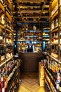 Liquor cellar inside the restaurant with sommerlier at cashier counter for help and giving information