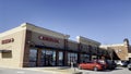 Liquor store exterior retail strip mall shopping center clear blue sky