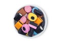 Liquorice Allsorts Sweets mixed in white ceramic plate on white background Royalty Free Stock Photo