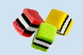 Liquorice Allsorts, Three different colours isolated on blue